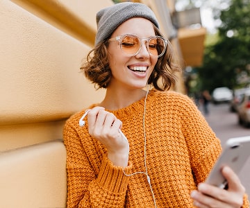 Smiling woman using a smartphone outdoors